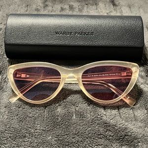 Warby Parker — Cateye sunglasses, peach colored, pink lenses.